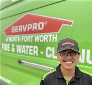 Male standing in front of green van with Servpro logo