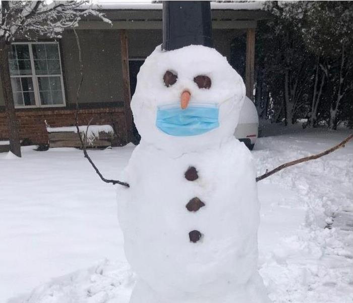 snowman in front of house